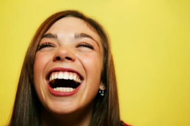 This woman is laughing at something funny.